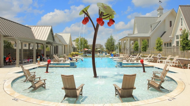 view of swimming pool featuring pool water feature and a patio area