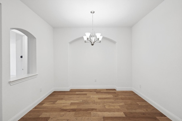 interior space with hardwood / wood-style floors and a notable chandelier