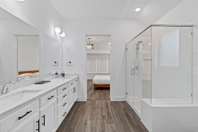 bathroom featuring wood-type flooring, an enclosed shower, and vanity