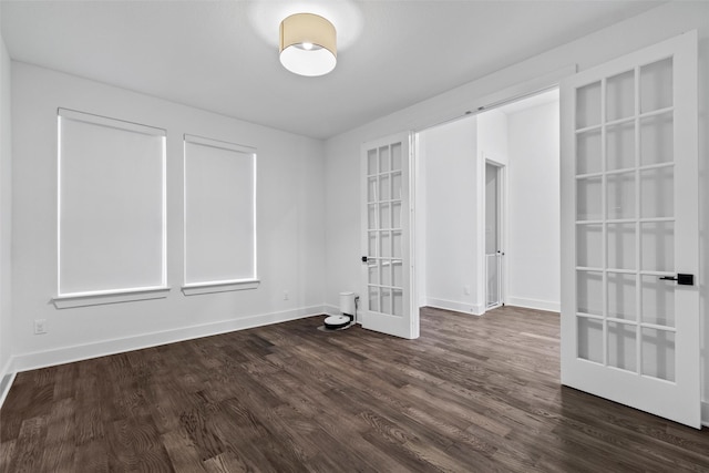 spare room featuring french doors and dark hardwood / wood-style floors