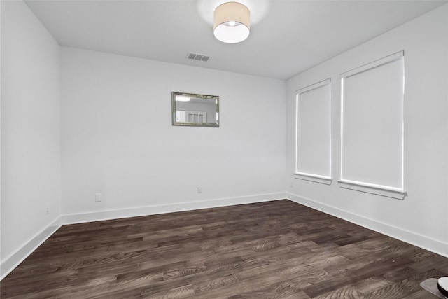 spare room with dark wood-type flooring