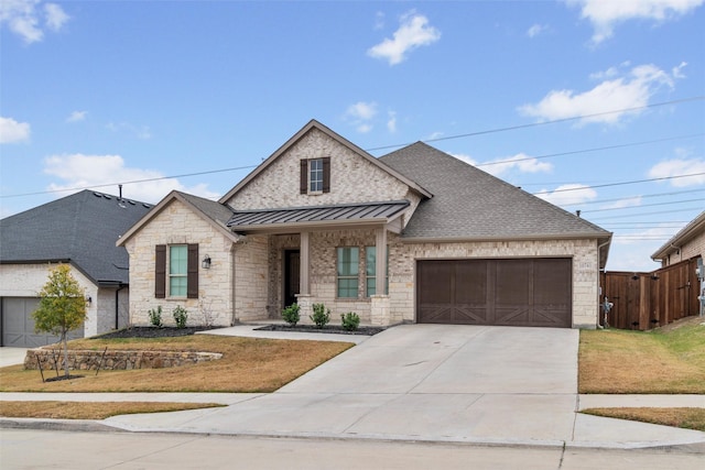 view of front of property with a front yard and a garage