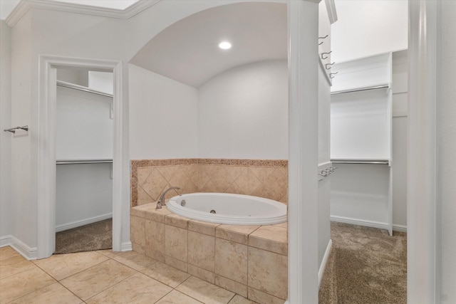 bathroom with tile patterned floors and tiled bath