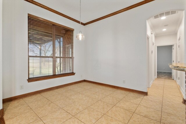 tiled empty room featuring ornamental molding