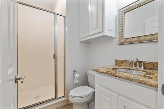 bathroom featuring a shower with door, tile patterned flooring, vanity, and toilet