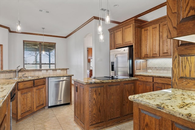 kitchen with stainless steel appliances, a sink, visible vents, and brown cabinets