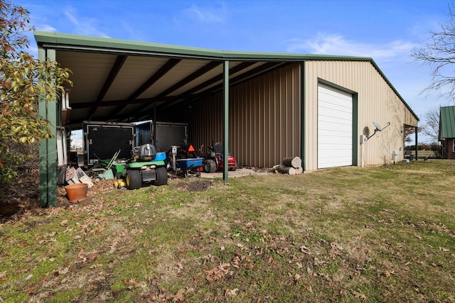 view of outbuilding with a lawn and a garage