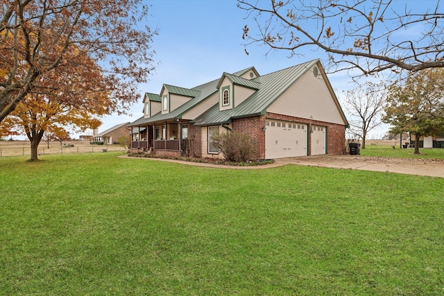 view of home's exterior with brick siding, concrete driveway, a lawn, a standing seam roof, and metal roof