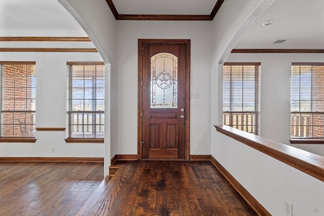 foyer with crown molding and dark hardwood / wood-style floors