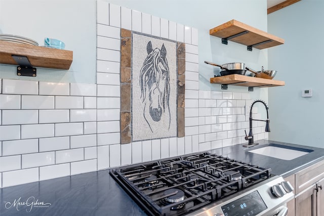 kitchen with gas range, sink, and decorative backsplash