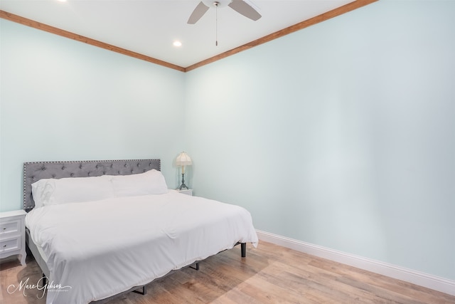 bedroom featuring ornamental molding, ceiling fan, and light hardwood / wood-style flooring