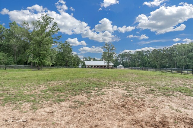 view of yard with a rural view