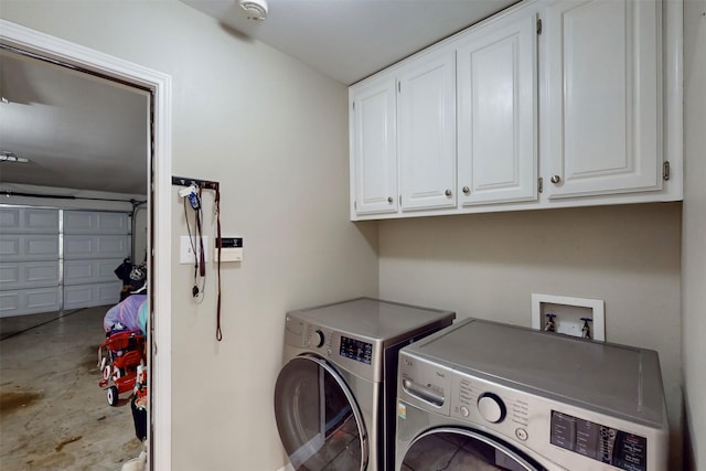 laundry area with cabinets and washer and clothes dryer