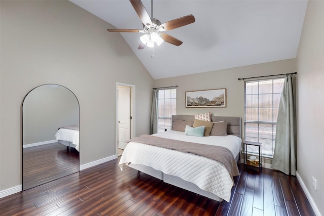 bedroom featuring dark hardwood / wood-style flooring, high vaulted ceiling, and ceiling fan