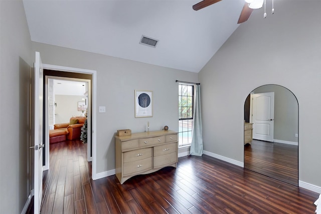 bedroom with ceiling fan, dark hardwood / wood-style flooring, and high vaulted ceiling