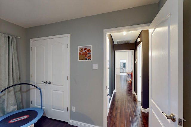 hallway with dark hardwood / wood-style flooring