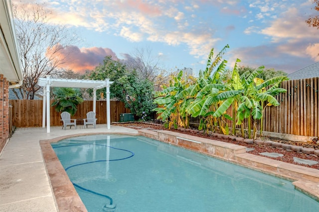 pool at dusk featuring a pergola