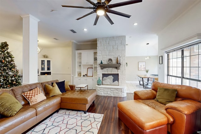 living room featuring a fireplace, hardwood / wood-style floors, ceiling fan, and ornamental molding