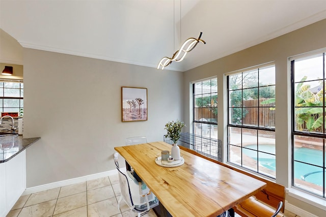 dining room with sink, light tile patterned floors, and ornamental molding