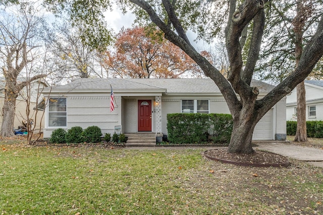 ranch-style home featuring a garage and a front yard