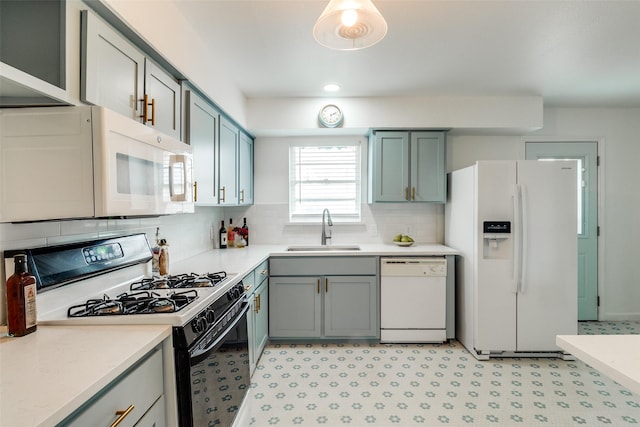 kitchen with white appliances, backsplash, and sink