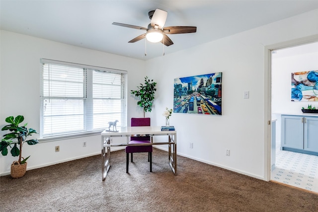 office with ceiling fan and dark carpet