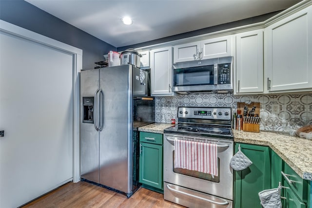 kitchen featuring appliances with stainless steel finishes, backsplash, white cabinetry, and green cabinets