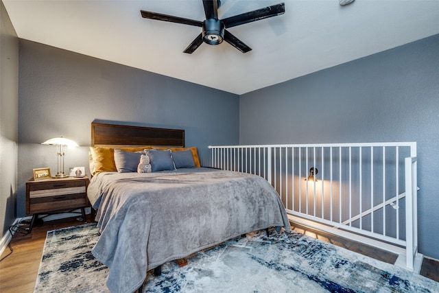 bedroom with ceiling fan and wood-type flooring