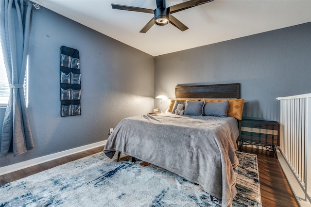 bedroom with ceiling fan, dark hardwood / wood-style flooring, and vaulted ceiling