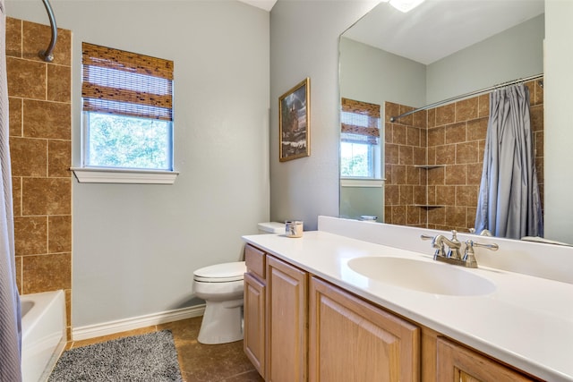 full bathroom with vanity, shower / tub combo, and toilet