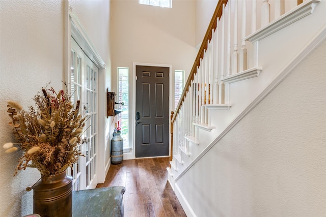 entryway with dark hardwood / wood-style flooring and french doors