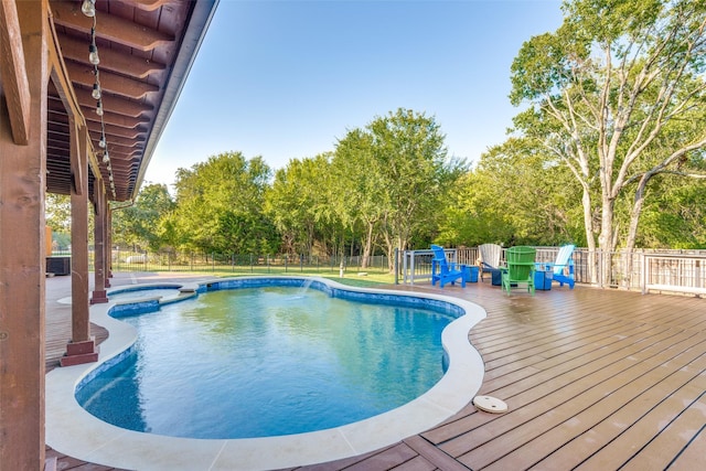 view of swimming pool with a wooden deck and an in ground hot tub