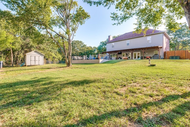 view of yard with a storage shed and a deck