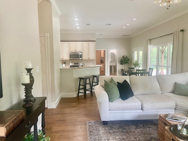 living room with crown molding and dark wood-type flooring