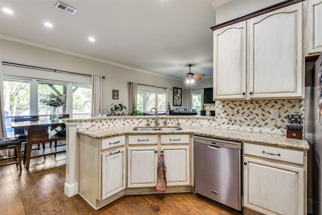 kitchen with appliances with stainless steel finishes, sink, backsplash, ornamental molding, and kitchen peninsula