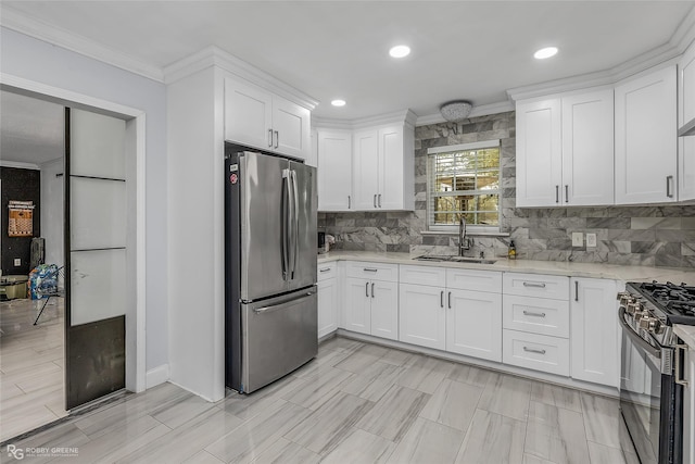 kitchen with white cabinets, appliances with stainless steel finishes, crown molding, and sink