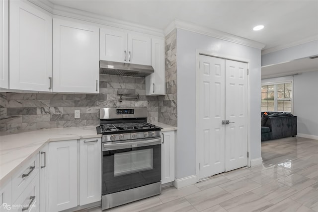 kitchen with tasteful backsplash, light stone counters, gas range, crown molding, and white cabinetry