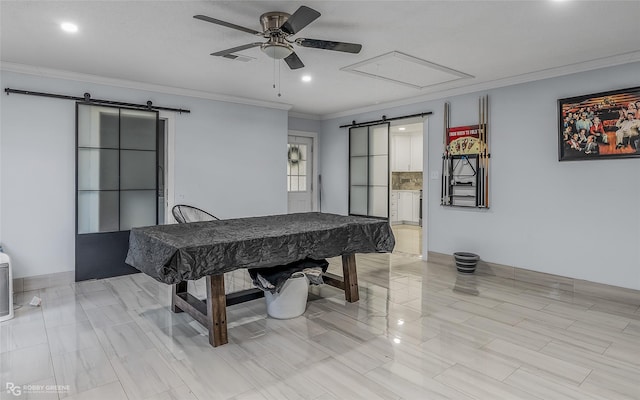 game room with a barn door, ceiling fan, crown molding, and pool table