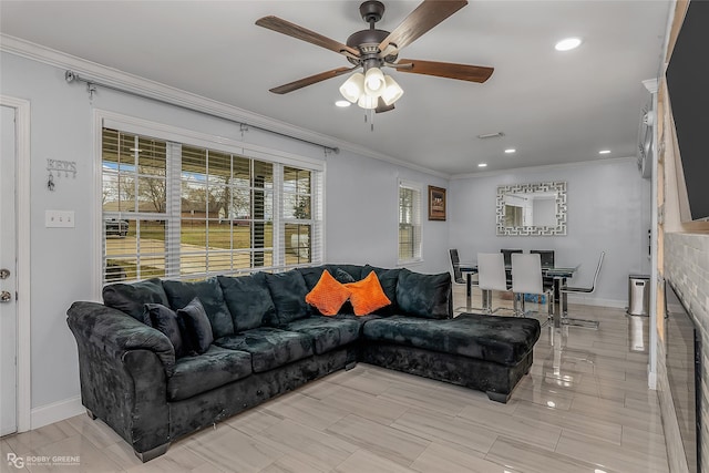 living room with ceiling fan and ornamental molding