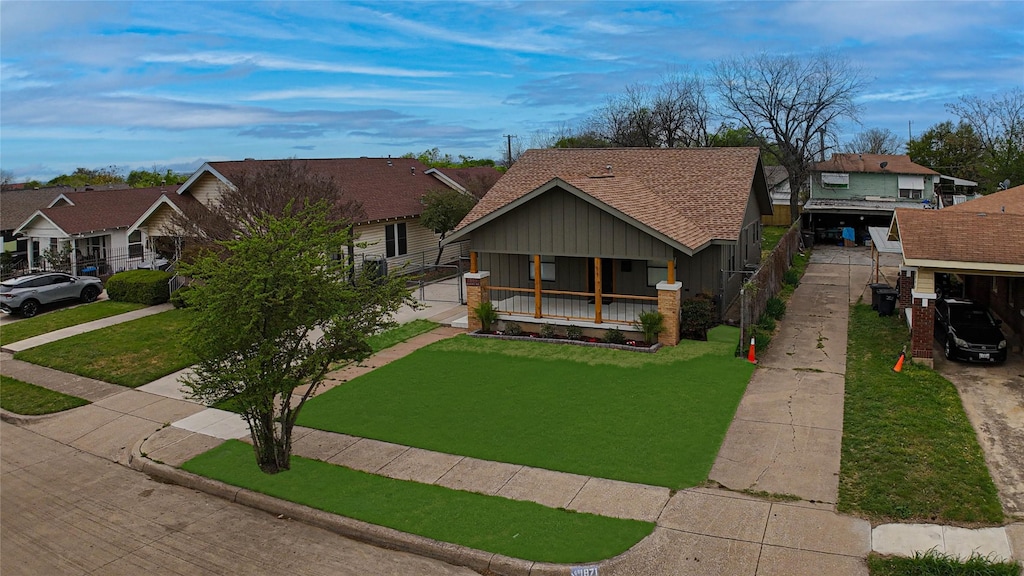 1869 Belmont Ave, Fort Worth, TX 76164 - view of front of property featuring a residential view, driveway, a front yard, and a porch