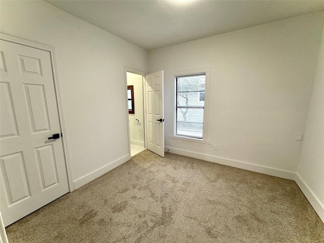 unfurnished bedroom with light carpet