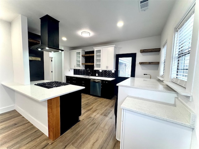 kitchen with ventilation hood, kitchen peninsula, stainless steel dishwasher, light wood-type flooring, and white cabinetry