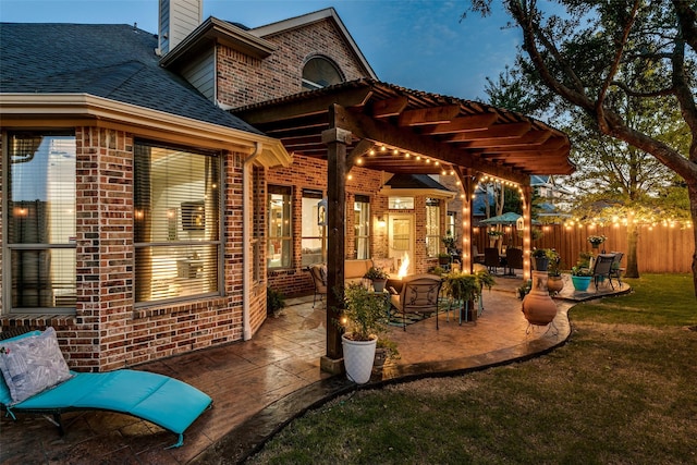 patio terrace at dusk featuring an outdoor living space with a fire pit