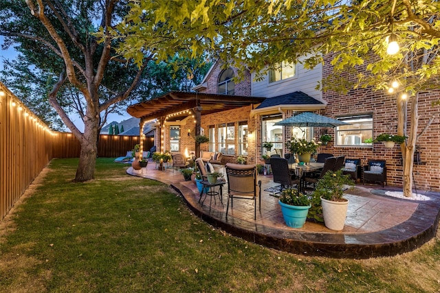 back of property featuring an outdoor living space, a patio area, a pergola, and a yard