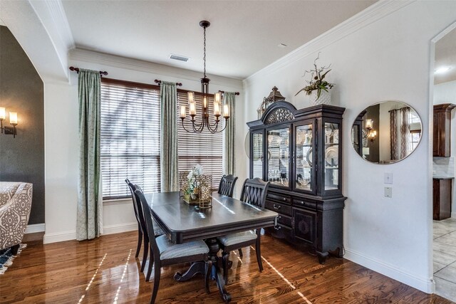 living room featuring a chandelier, wood-type flooring, lofted ceiling, and ornamental molding