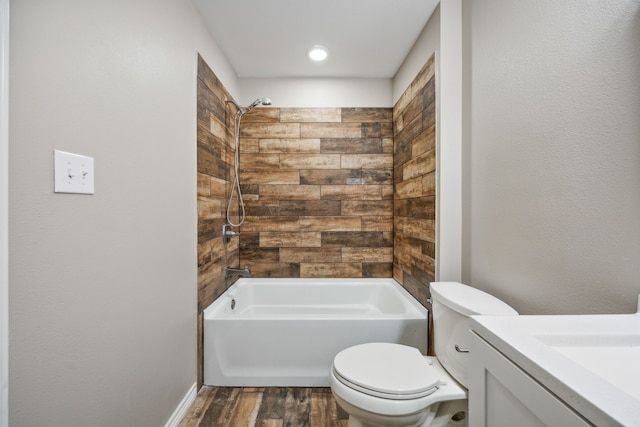 full bathroom with vanity, toilet, wood-type flooring, and tiled shower / bath