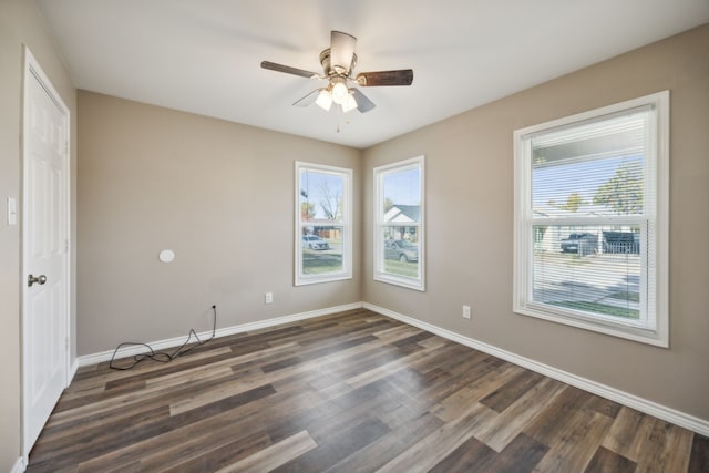 spare room featuring ceiling fan and dark wood-type flooring