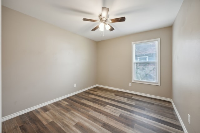 spare room featuring ceiling fan and dark hardwood / wood-style flooring