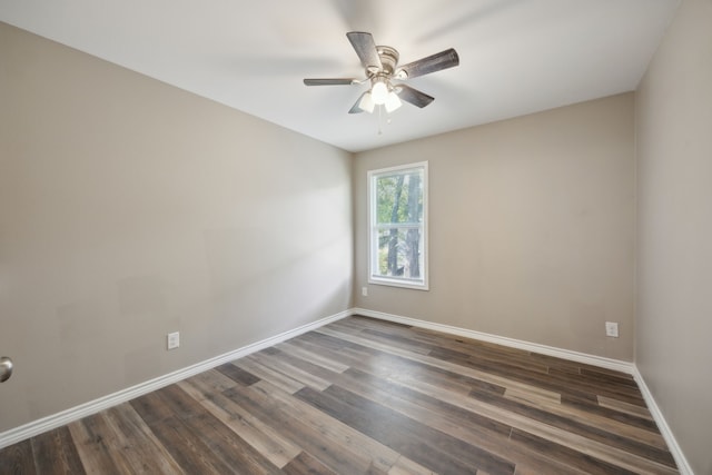 empty room with ceiling fan and dark wood-type flooring