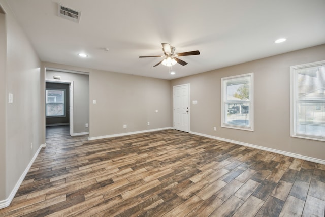 spare room with ceiling fan and dark wood-type flooring